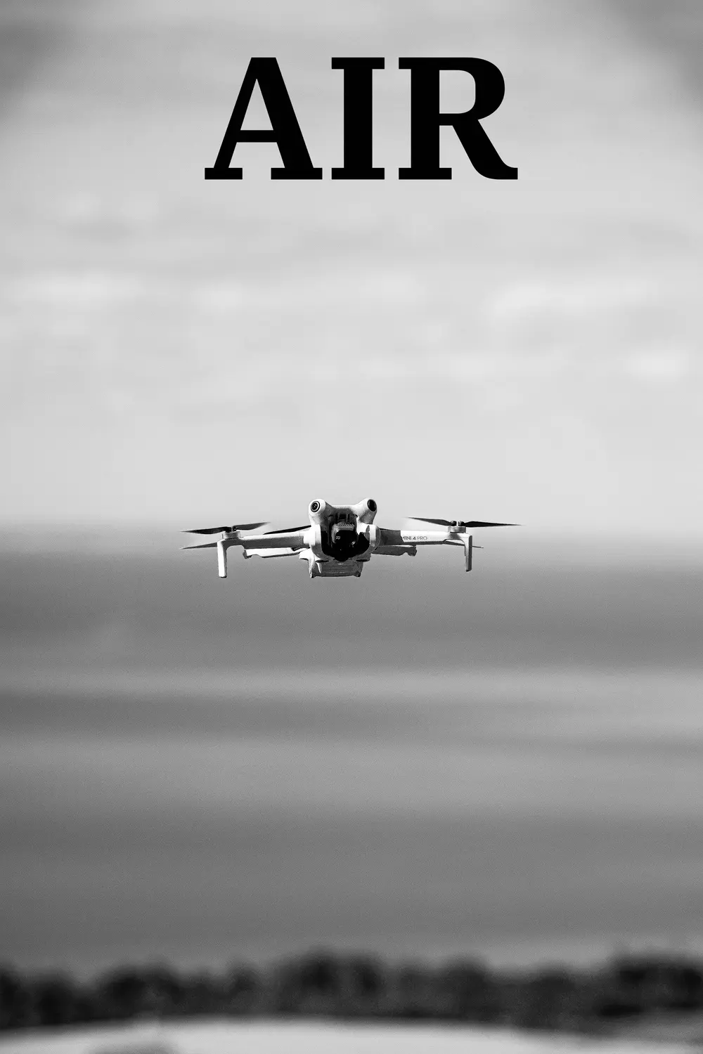 Air: a small drone in flight over a blurred landscape